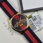 Gucci G-Timeless Gold Stainless Steel Quartz Blue/Red with Embroidered Bee Design Dial Navy/Red Nylon Band Women’s Watch YA1264061